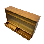 Load image into Gallery viewer, A mid-century modern wooden display cabinet with glass doors and two pull-out drawers, shown on a plain white background.
