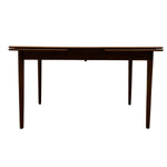 Load image into Gallery viewer, A dark brown wooden extendable dining table with a slatted top and four tapered legs, shown from a front angle on a plain white background.
