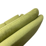 Load image into Gallery viewer, Close-up of an upholstered armrest or chair cushion in a muted olive green fabric, showing the texture and curved shape against a plain white background.
