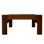 Load image into Gallery viewer, A mid-century modern wooden low stool or bench with a warm brown finish, featuring a thick rectangular seat, blocky legs, and angled support brackets underneath, shown against a plain white background.
