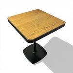 Load image into Gallery viewer, Wooden table with black base on a white background
