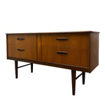 Load image into Gallery viewer, Mid-century modern wooden dresser with six drawers, featuring a warm medium-brown wood grain finish and dark metal oval handles, shown on a plain white background.

