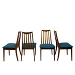 Load image into Gallery viewer, Four mid-century modern wooden dining chairs with dark teal upholstered seats, shown from the front and side against a plain white background.
