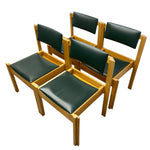 Load image into Gallery viewer, Four wooden dining chairs with dark green upholstered seats and backrests, arranged on a plain white background.
