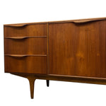 Load image into Gallery viewer, Mid-century modern wooden sideboard with three drawers on the left and a cabinet door on the right, featuring curved wooden handles and tapered legs, shown against a plain white background.
