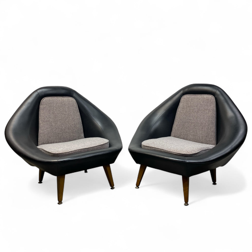 Pair of black lounge chairs with gray cushions on a white background
