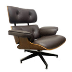 Load image into Gallery viewer, A mid-century modern lounge chair with dark brown leather upholstery, a wood-grain side panel, and a black five-star metal base, shown against a plain white background.
