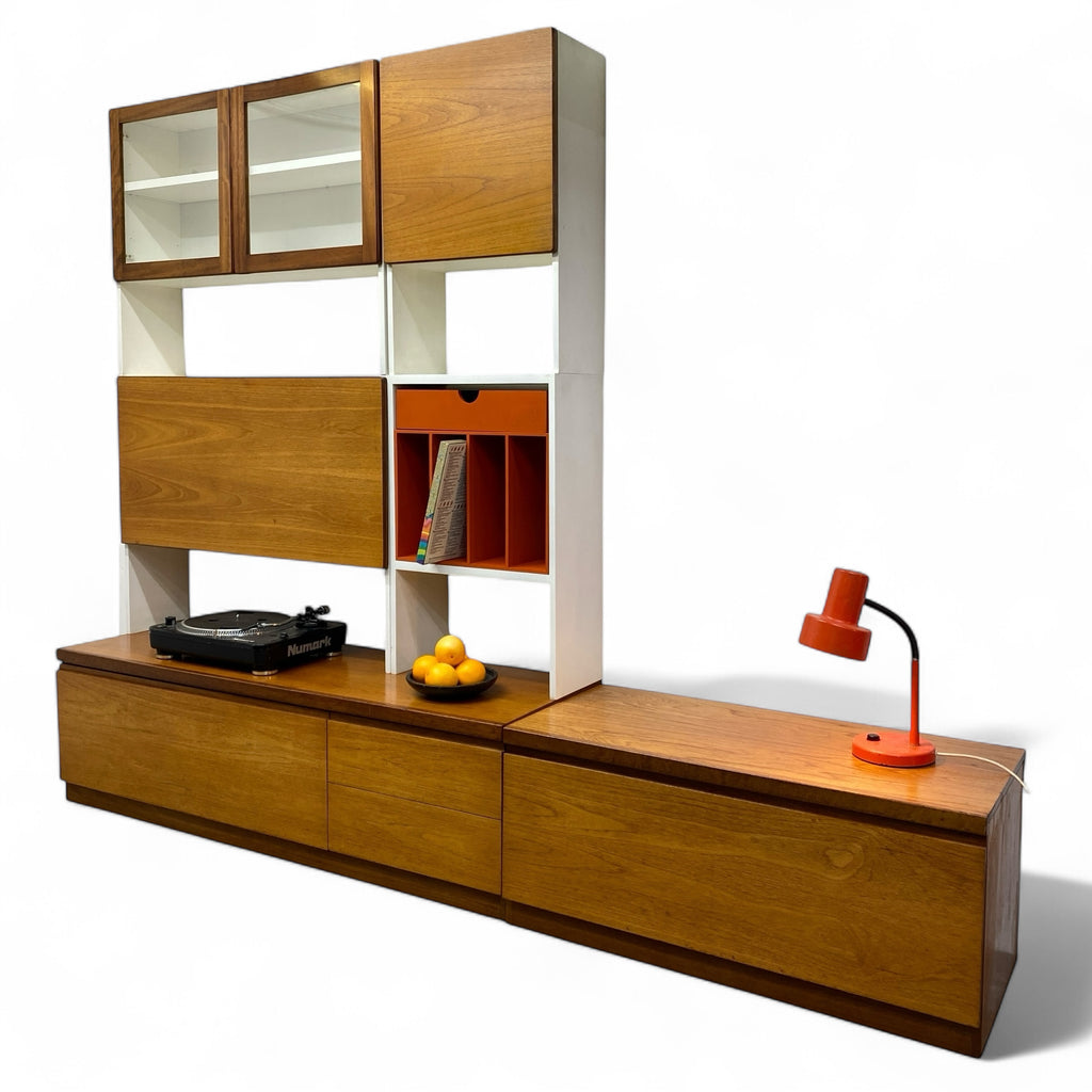 Wooden entertainment console with shelves and a lamp on a white background