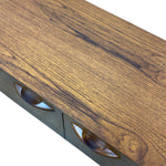 Load image into Gallery viewer, Close-up of a wooden cabinet or sideboard showing a warm medium-brown wood grain top, a dark metal frame, and two oval drawer pulls on a white background.

