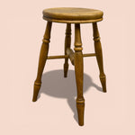 Load image into Gallery viewer, Wooden stool with a round seat on a beige background
