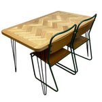 Load image into Gallery viewer, Wooden table with two green metal chairs on a white background
