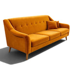 Load image into Gallery viewer, A modern three-seater sofa upholstered in mustard yellow velvet fabric, featuring a tufted backrest, rolled arms, and tapered wooden legs, shown on a white background with a soft shadow.
