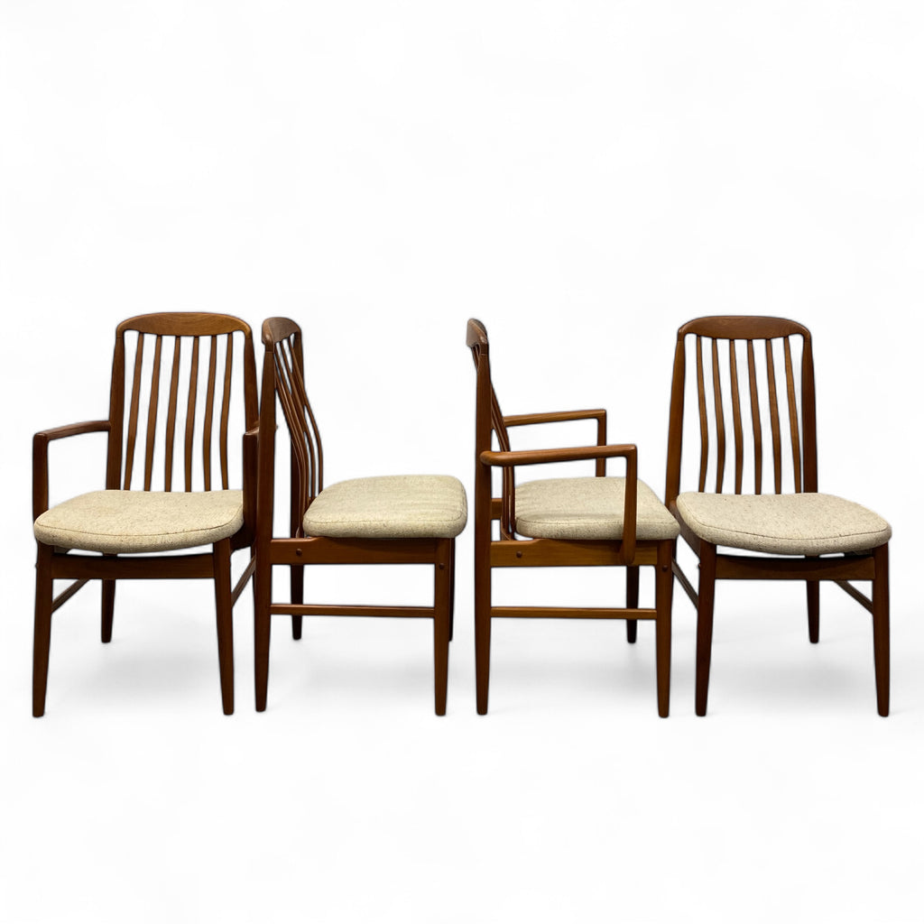 Set of four wooden chairs with beige cushions on a white background