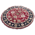 Load image into Gallery viewer, Round floral-patterned rug with red and blue colors on a white background
