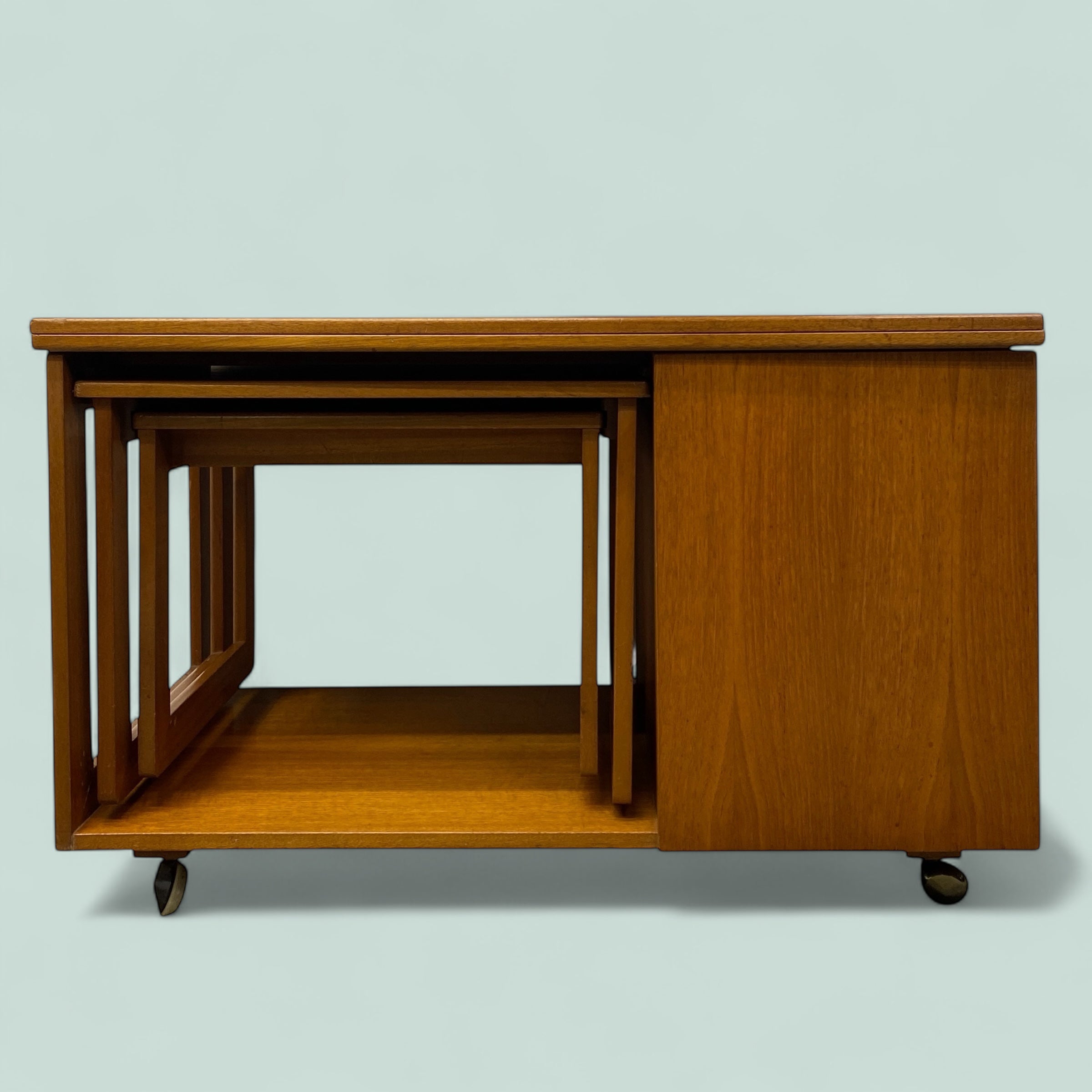 Set of wooden nesting tables on a light gray background