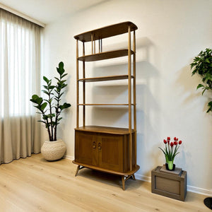Wooden bookshelf in a room with plants and a curtain