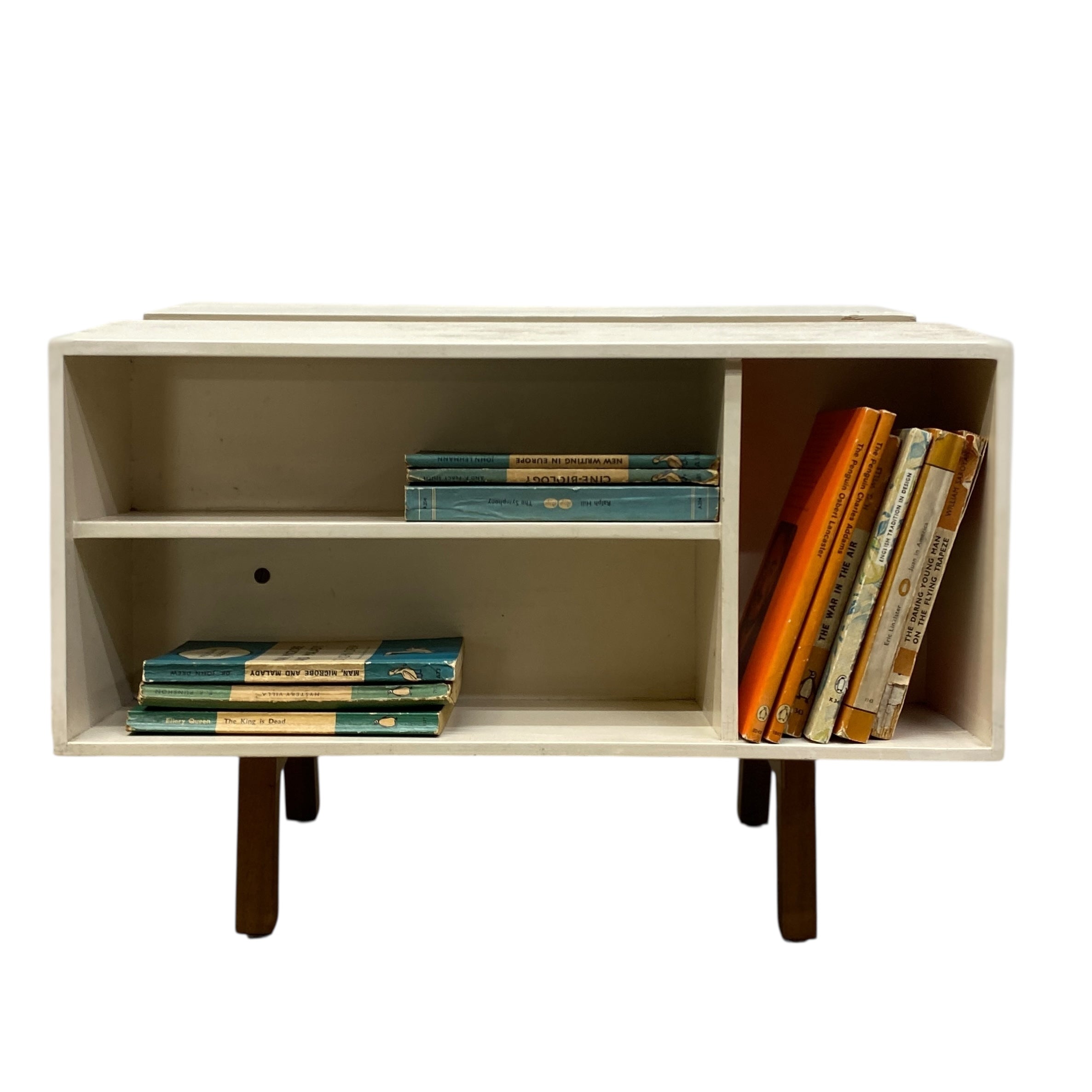Beige bookshelf with books on a white background