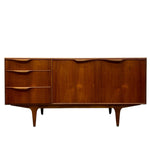 Load image into Gallery viewer, Mid-century modern wooden sideboard with three drawers on the left and three cabinet doors on the right, featuring tapered legs and a warm walnut finish, shown against a plain white background.
