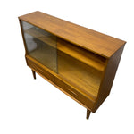 Load image into Gallery viewer, Mid-century modern wooden sideboard cabinet with glass-front upper doors, open shelves, and two lower drawers, shown on a plain white background.
