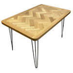 Load image into Gallery viewer, Wooden table with herringbone pattern and black hairpin legs on a white background
