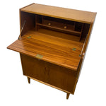 Load image into Gallery viewer, Mid-century modern wooden writing desk cabinet with open hinged doors, a folded-out writing surface, two small top drawers, and brass hardware, shown on a white background.
