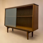 Load image into Gallery viewer, Wooden cabinet with a glass door on a beige background
