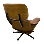 Load image into Gallery viewer, A mid-century modern lounge chair with a curved wooden shell, brown leather upholstery, and a black five-star swivel base, shown from a rear three-quarter angle on a white background.
