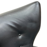 Load image into Gallery viewer, Close-up of a black leather chair with a buttoned backrest on a white background
