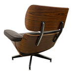 Load image into Gallery viewer, Mid-century modern lounge chair with a curved wooden shell, dark brown wood grain, black leather cushion, and black metal five-star base, shown from a three-quarters angle on a white background.
