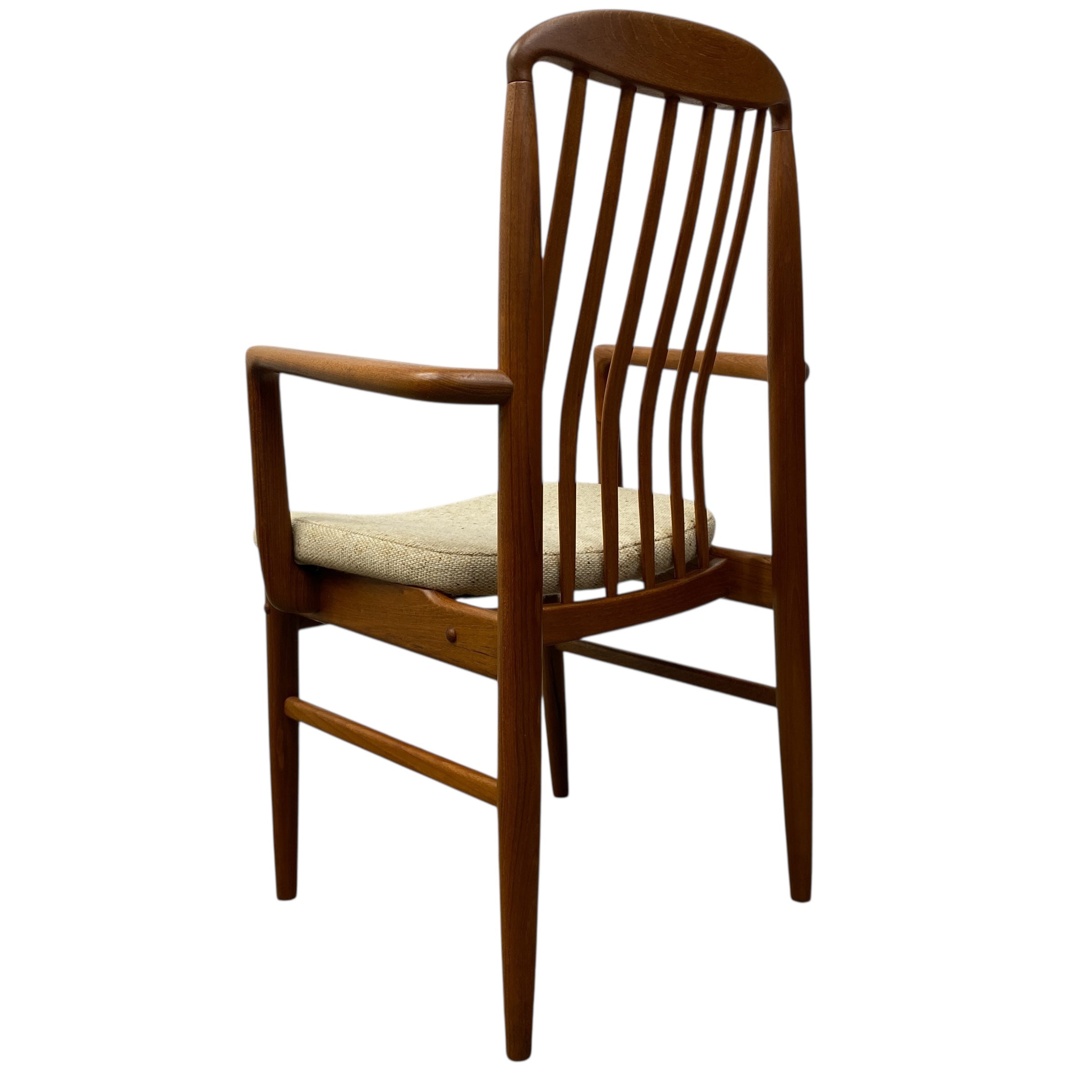 Wooden chair with a cushioned seat on a white background