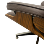Load image into Gallery viewer, A close-up of a mid-century modern lounge chair with dark brown leather upholstery and a curved wooden shell, shown on a white background.
