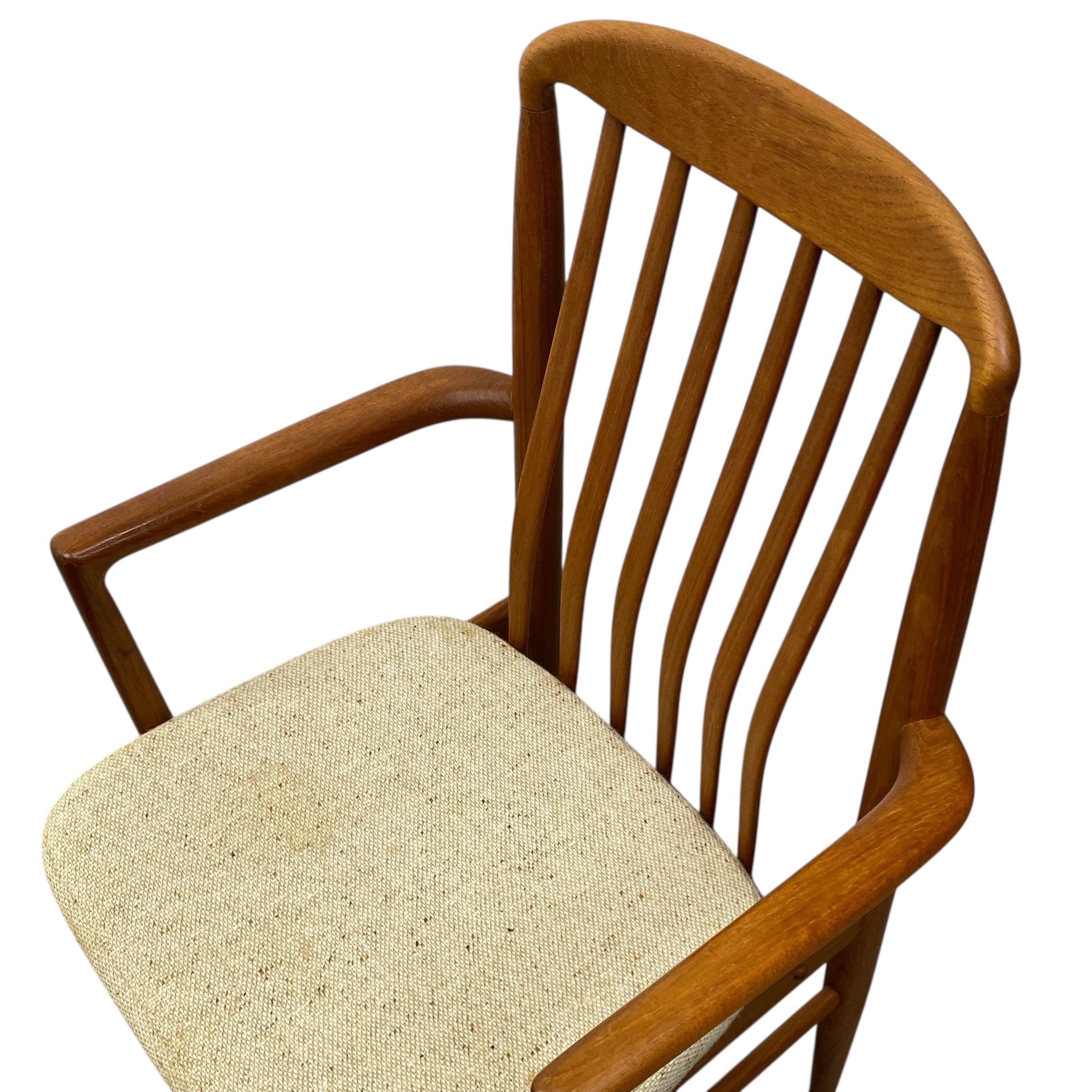 Wooden chair with beige cushion on a white background