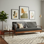 Load image into Gallery viewer, Modern living room with a gray sofa, teal armchair, and abstract art on the wall.
