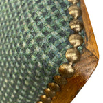 Load image into Gallery viewer, Close-up of a green textured fabric with gold beading and wooden trim.
