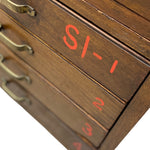 Load image into Gallery viewer, Close-up of a dark brown wooden drawer organizer with brass handles and red printed drawer labels numbered 1 through 4.
