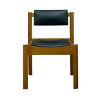 Load image into Gallery viewer, A mid-century modern wooden dining chair with a warm brown wood frame and black padded seat and backrest, shown against a plain white background.
