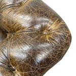 Load image into Gallery viewer, A close-up of a dark brown tufted leather armrest, showing the detailed texture, cracks, and brass button hardware against a white background.
