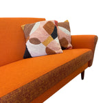 Load image into Gallery viewer, Orange sofa with patterned cushions on a white background
