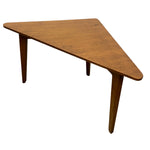 Load image into Gallery viewer, A triangular wooden corner table with a warm medium-brown finish and tapered legs, shown on a plain white background.

