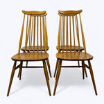 Load image into Gallery viewer, Two wooden chairs with spindle backs on a white background
