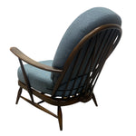 Load image into Gallery viewer, Blue cushioned chair with wooden frame on a white background
