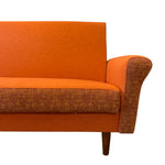 Load image into Gallery viewer, Orange sofa with brown armrests on a white background
