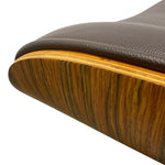 Load image into Gallery viewer, Close-up of a mid-century modern chair corner showing a dark brown textured leather seat cushion, a light wood veneer edge, and a curved wood shell backrest on a white background.
