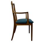 Load image into Gallery viewer, A mid-century modern wooden dining chair with a curved backrest, armrests, and a teal blue upholstered seat cushion, shown from a side profile on a white background.
