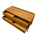 Load image into Gallery viewer, Mid-century modern wooden storage cabinet with a warm honey-toned wood finish, featuring five drawers in varying positions and small round metal pulls, shown on a plain white background.
