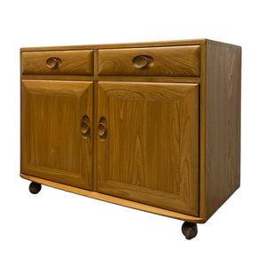Wooden cabinet with two doors and two drawers on a white background