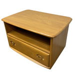 Load image into Gallery viewer, A mid-century modern wooden side table or low cabinet with a warm honey-wood finish, featuring a top shelf and two drawers with circular pulls, shown on a plain white background.
