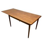 Load image into Gallery viewer, A mid-century modern wooden extendable dining table with a warm medium-brown wood finish, shown on a plain white background.
