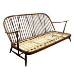 Load image into Gallery viewer, Mid-century modern wooden futon sofa with a curved spindle-back design, featuring a warm brown frame and light natural wood slatted seat and backrest, isolated on a white background.
