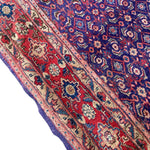 Load image into Gallery viewer, Close-up of a patterned rug with red, blue, and beige colors.
